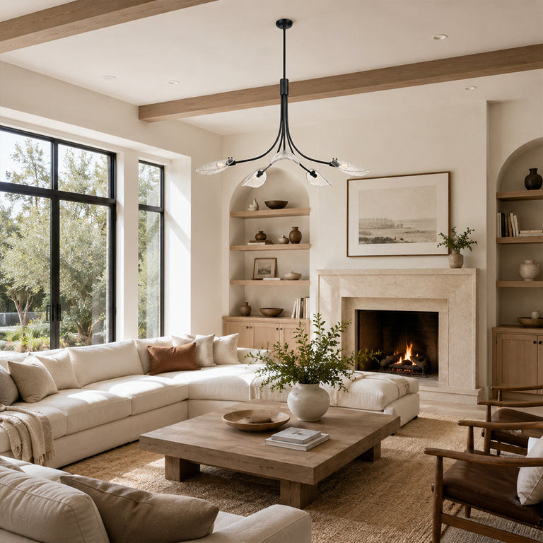Black leaf glass chandelier in a living room with a fireplace