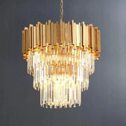 Illuminated crystal cascade beneath a gold-tone metal crown against a dark background.