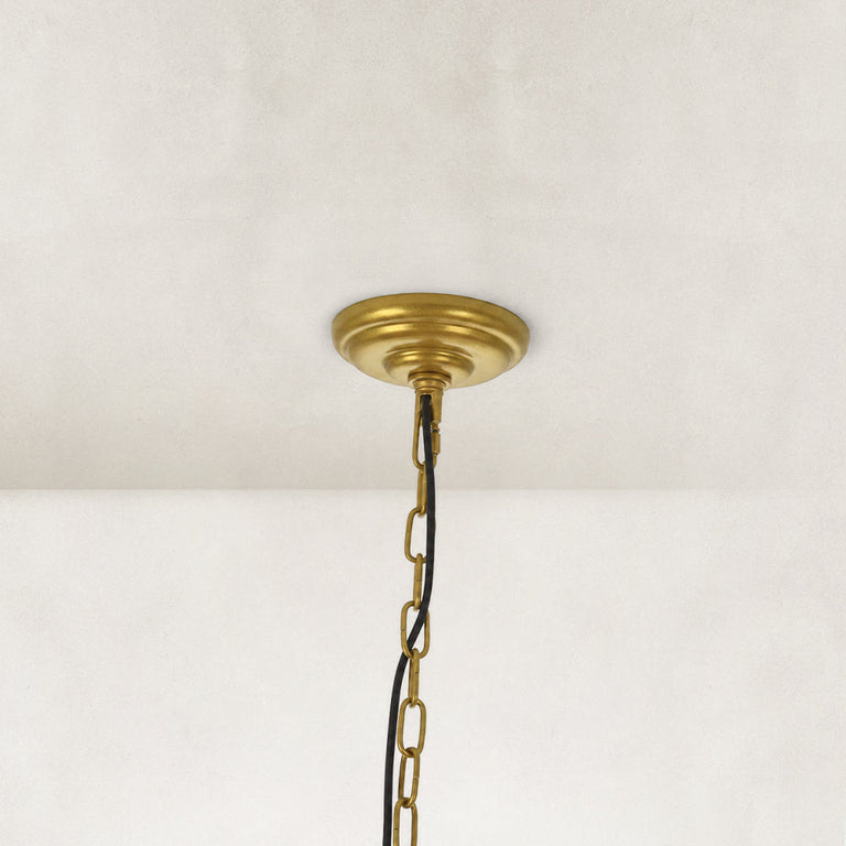 Candle ring chandelier, gold-tone ceiling canopy and chain close view.