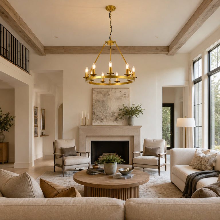 Candle ring chandelier over a round coffee table in a beam-ceiling living room.