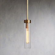 Illuminated single glass cylinder pendant with a brass-tone cap and rod.