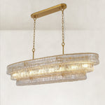 Clear glass linear chandelier at an angle with canopy and chains.