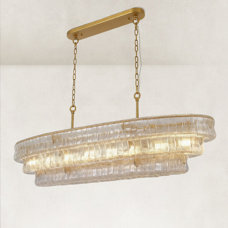 Clear glass linear chandelier at an angle with canopy and chains.