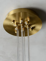 Close-up of the brass-colored ceiling canopy and suspension wire fittings