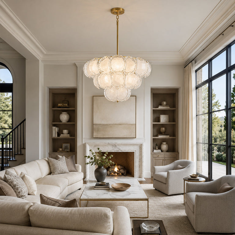 Three-tier petal glass chandelier in a high-ceiling living room with a fireplace.
