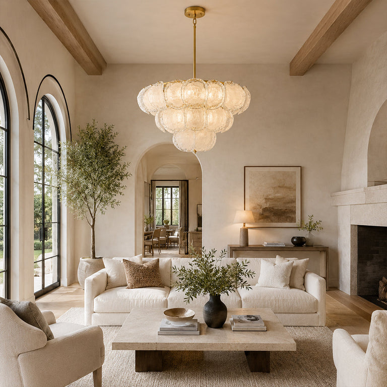 Three-tier petal glass chandelier over a living room with exposed ceiling beams.