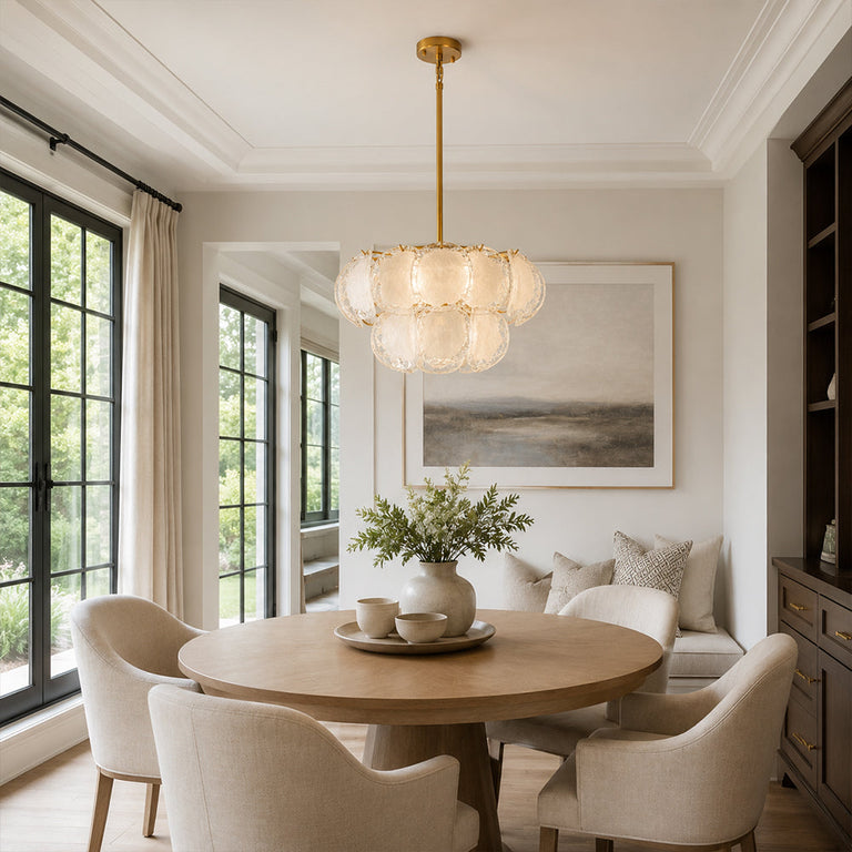 Two-tier petal glass chandelier above a round dining table by tall windows.