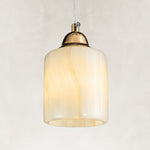 Cloud Onyx Cylinder Pendant illuminated as a complete fixture