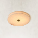 Illuminated Cora alabaster ceiling light against a neutral background