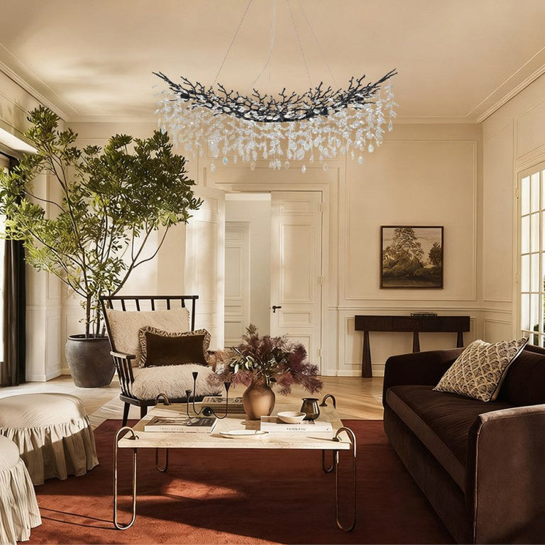 Black branch chandelier in a living room with sofas.