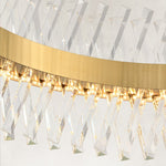 Clear faceted crystal prisms and brass-tone ring close-up.