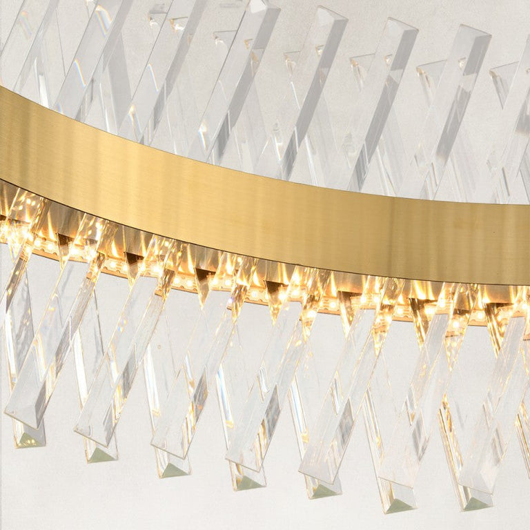 Clear faceted crystal prisms and brass-tone ring close-up.