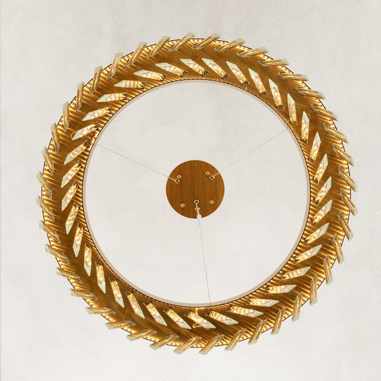 Underside view of the round brass-tone crystal prism ring.