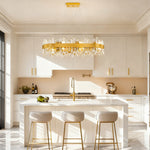 Oval crystal chandelier above a kitchen island.