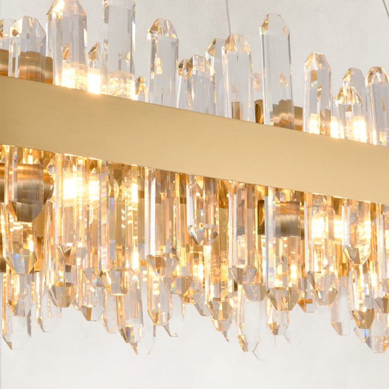 Illuminated clear rods along the oval chandelier band.