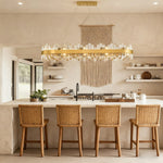 Oval crystal chandelier above a kitchen island.