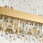 Unlit clear rods and gold-tone oval chandelier band.