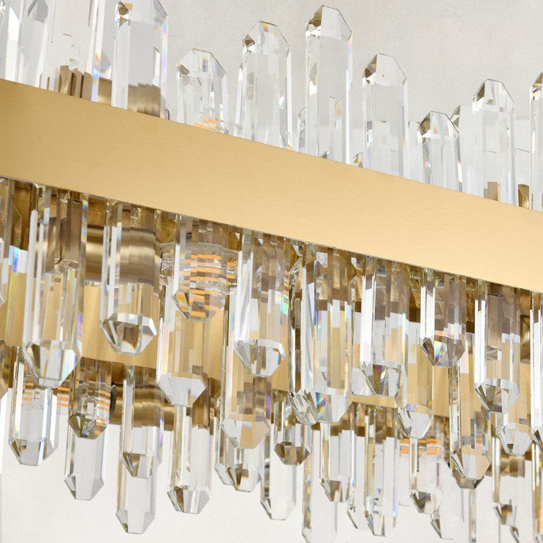 Unlit clear rods and gold-tone oval chandelier band.