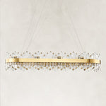 Unlit oval chandelier with a gold-tone band and clear rods.