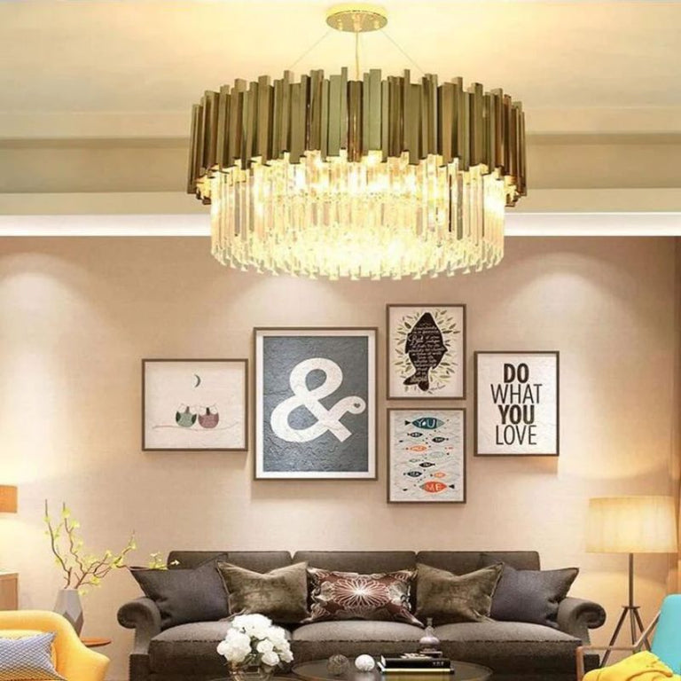 Illuminated crystal crown drum chandelier above a sofa in a furnished interior.