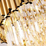 Close-up of illuminated crystal rods below the flush mount's metal crown.