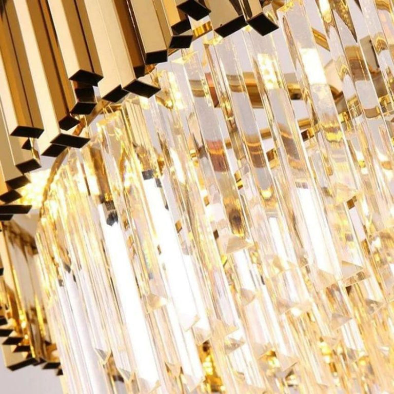 Close-up of illuminated crystal rods below the flush mount's metal crown.