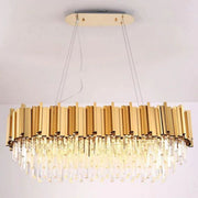 Illuminated oval crystal chandelier hanging from a gold-tone canopy.