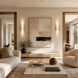 Alabaster Column Wall Sconce, 20 in in Brass beside wall art in a living room
