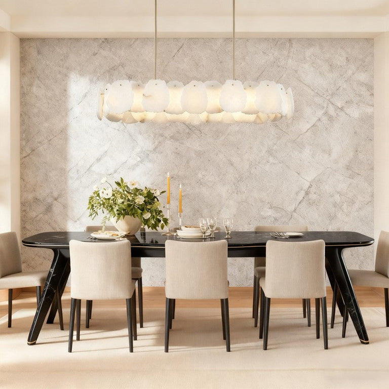Brass alabaster petal oval chandelier illuminated above a dining table