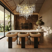 Brass-finish crystal branch cascade chandelier above a dining table