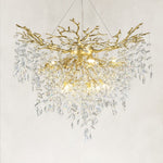 Illuminated brass-finish crystal branch chandelier with a deep cascade of drops