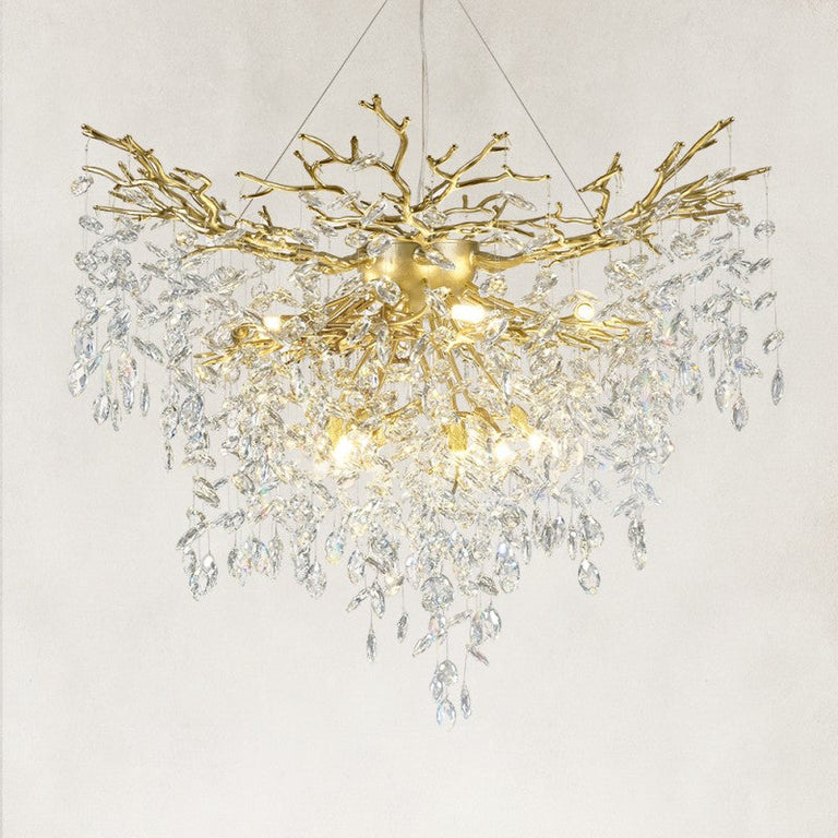 Illuminated brass-finish crystal branch chandelier with a deep cascade of drops
