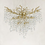 Unlit brass-finish crystal branch chandelier with a deep cascade of drops