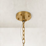 Angled view of the gold-tone chandelier canopy and chain.
