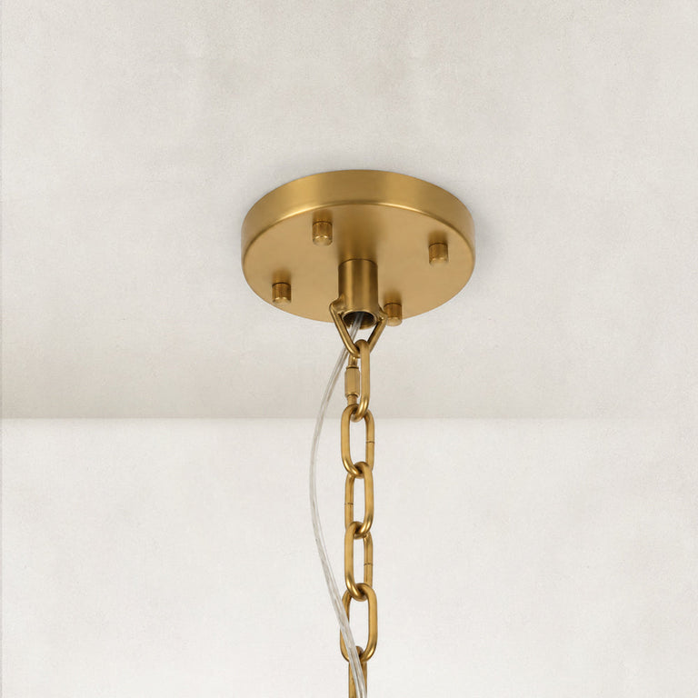 Angled view of the gold-tone chandelier canopy and chain.