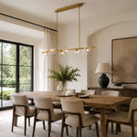 Gold-tone bubble glass chandelier above a dining table in an interior setting