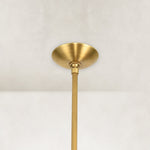 Gold-tone chandelier ceiling canopy and stem close view