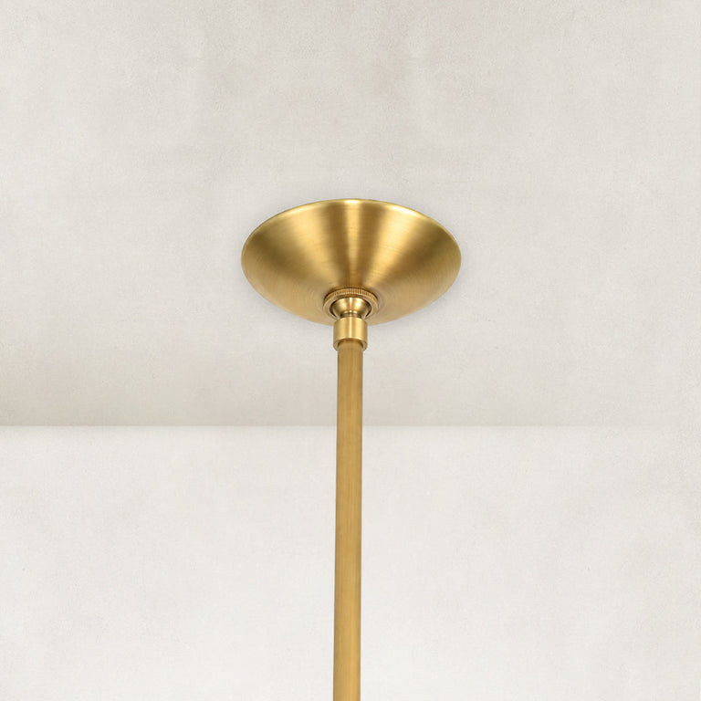 Gold-tone chandelier ceiling canopy and stem close view