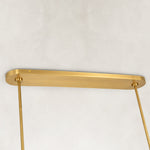 Gold-tone chandelier ceiling canopy and suspension rods close view