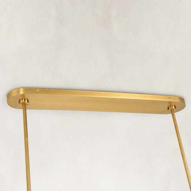 Gold-tone chandelier ceiling canopy and suspension rods close view