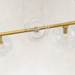 Gold-tone chandelier glass globes and light sockets close view