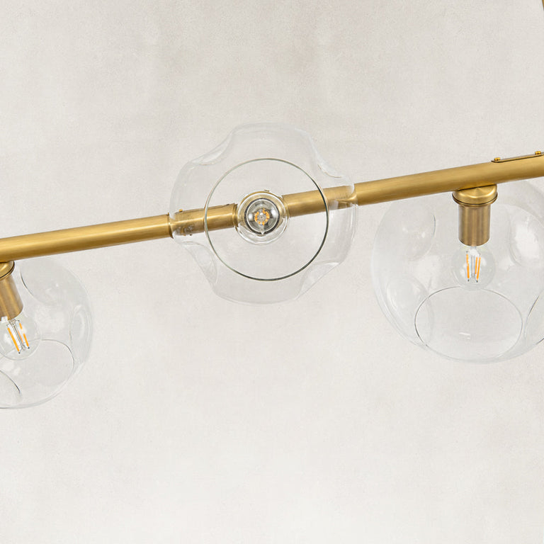 Gold-tone chandelier glass globes and light sockets close view
