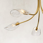 Gold-tone chandelier glass shades and lamp holders close view