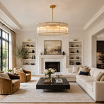 Gold-tone glass rod drum chandelier in a living room with a fireplace