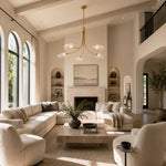 Gold-tone leaf glass chandelier in a bright living room interior