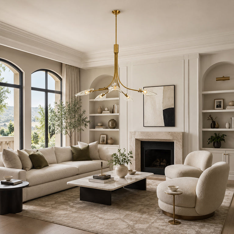 Gold-tone leaf glass chandelier in a living room with a fireplace