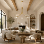 Gold-tone leaf glass chandelier in a living room with exposed beams