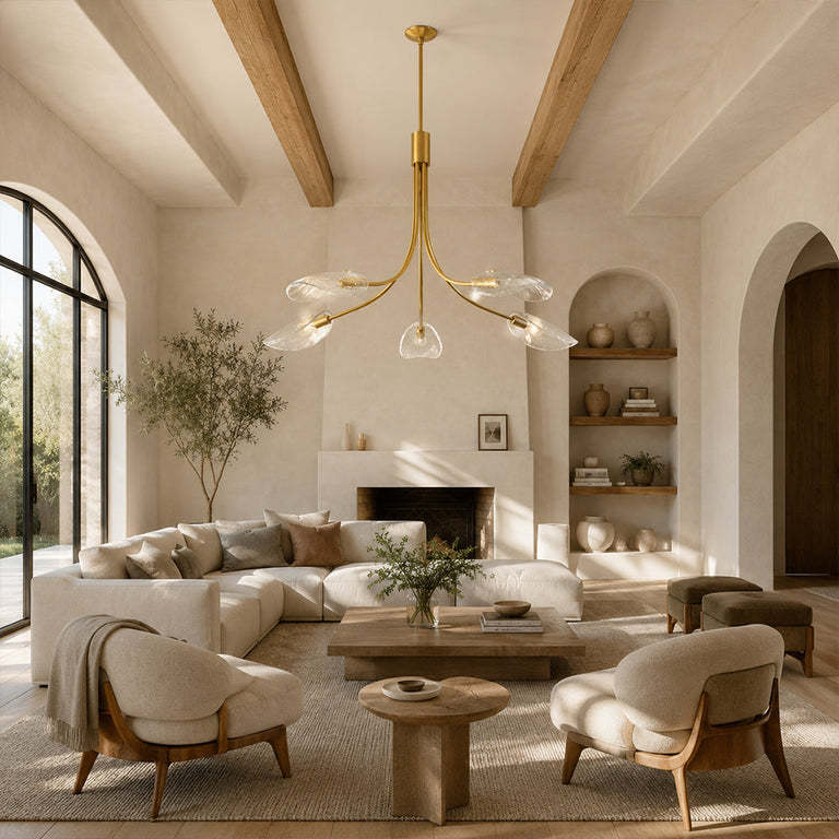 Gold-tone leaf glass chandelier in a living room with exposed beams