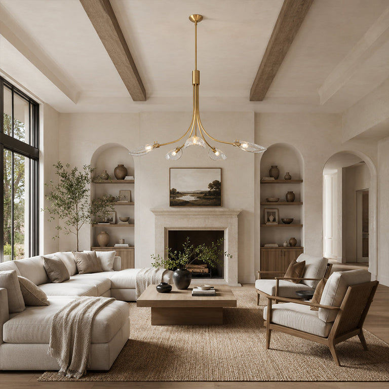 Gold-tone leaf glass chandelier in a living room with exposed ceiling beams