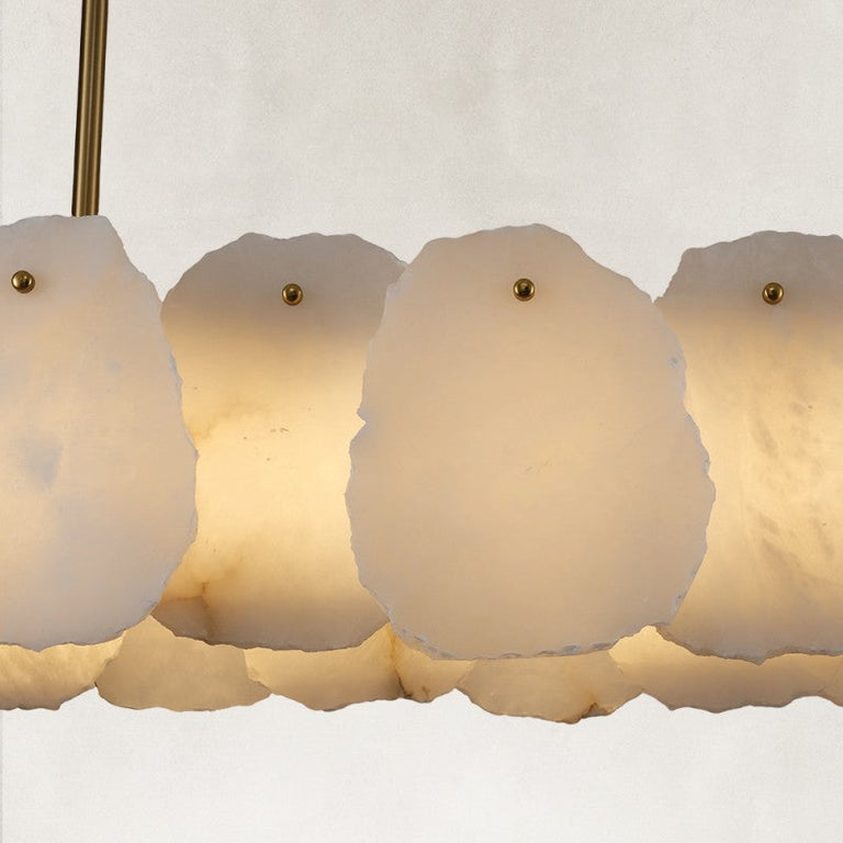 Gold-tone oval chandelier illuminated petal shade close view